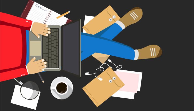 Person sitting down with laptop and papers around them