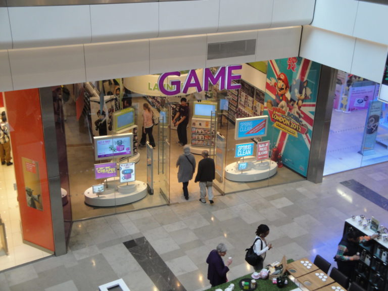 People walking into a game store in the mall